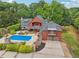 Stately two-story home features a private pool, lush landscaping, charming balconies, and an attached two-car garage at 150 Henderson Farm Dr, Woodstock, GA 30188