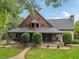 Charming home with a manicured front lawn, stone accents, and a welcoming front porch at 150 Henderson Farm Dr, Woodstock, GA 30188