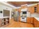 Well-equipped kitchen with stainless steel appliances, custom wood cabinets, and hardwood floors at 150 Henderson Farm Dr, Woodstock, GA 30188