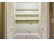 A large closet with bi-fold doors, shelving, tile floors and washing machine and electrical hookups at 150 Henderson Farm Dr, Woodstock, GA 30188