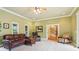 Spacious living room with leather furniture, ceiling fan, and entry to another room at 150 Henderson Farm Dr, Woodstock, GA 30188