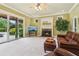 Cozy living room features a fireplace, comfortable seating, and sliding doors to the outdoor pool area at 150 Henderson Farm Dr, Woodstock, GA 30188