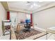 Bright office space with ample natural light, a ceiling fan, and a large decorative rug at 150 Henderson Farm Dr, Woodstock, GA 30188