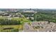 Aerial view of townhomes next to a green space, with city buildings in background at 2501 Painted Buckeye Chase Se, Smyrna, GA 30080