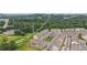 Aerial view of townhomes next to a green space, with city skyline background at 2501 Painted Buckeye Chase Se, Smyrna, GA 30080