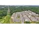 Aerial view of townhomes next to a green space, with city buildings in background at 2501 Painted Buckeye Chase Se, Smyrna, GA 30080