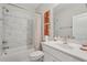 Bright, marbled tile bathroom with tub, shower, patterned curtain, and white vanity with sink at 2501 Painted Buckeye Chase Se, Smyrna, GA 30080
