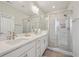 Bright bathroom with dual sinks, modern fixtures, and a glass-enclosed shower stall at 2501 Painted Buckeye Chase Se, Smyrna, GA 30080