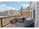Outdoor deck area with wicker furniture, a patio umbrella, and a view of the neighborhood at 2501 Painted Buckeye Chase Se, Smyrna, GA 30080