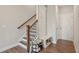 Hallway with a staircase with an adjacent built-in coat rack with bench and shoe storage underneath at 2501 Painted Buckeye Chase Se, Smyrna, GA 30080