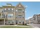 Beautiful three-story townhouse with neutral brick, dark shutters, and well-manicured lawn at 2501 Painted Buckeye Chase Se, Smyrna, GA 30080