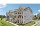 Exterior view of modern townhomes with a combination of brick, siding, large windows, and manicured lawns at 2501 Painted Buckeye Chase Se, Smyrna, GA 30080