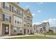 Attractive three-story townhouse with brick and siding accents, offering a cozy neighborhood feel at 2501 Painted Buckeye Chase Se, Smyrna, GA 30080