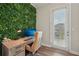 Bright home office featuring a wooden desk and a unique green living wall backdrop at 2501 Painted Buckeye Chase Se, Smyrna, GA 30080
