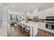 Modern kitchen with stainless appliances, white cabinets, large island and view to the adjacent living room at 2501 Painted Buckeye Chase Se, Smyrna, GA 30080