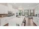 Gourmet kitchen featuring white cabinetry, tile backsplash, stainless appliances, and a large kitchen island at 2501 Painted Buckeye Chase Se, Smyrna, GA 30080