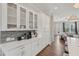 Kitchen area showcasing white cabinetry with glass fronts and view to the living room area at 2501 Painted Buckeye Chase Se, Smyrna, GA 30080