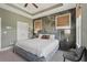 Beautiful main bedroom features patterned wall, tray ceiling, and plush bedding at 2501 Painted Buckeye Chase Se, Smyrna, GA 30080