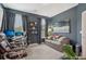 Office space featuring dark walls, a TV, multiple chairs, a sofa, and shelving at 2501 Painted Buckeye Chase Se, Smyrna, GA 30080