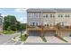 Stylish townhomes featuring a back deck overlooking a two-car garage and lush landscaping at 2501 Painted Buckeye Chase Se, Smyrna, GA 30080