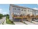 Stylish townhomes featuring a back deck overlooking a two-car garage and lush landscaping at 2501 Painted Buckeye Chase Se, Smyrna, GA 30080