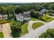 A stunning aerial view of this two-story home shows the circular driveway, landscaping, and neighborhood at 1670 Burnt Oak Way, Dacula, GA 30019