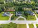 Aerial view of a home with mature trees, a manicured lawn, and a long driveway in a suburban neighborhood at 1670 Burnt Oak Way, Dacula, GA 30019