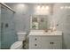 Bright bathroom with marble tile, a glass shower, and a white vanity at 1670 Burnt Oak Way, Dacula, GA 30019