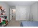Bedroom featuring light gray walls, carpet flooring, and closet access at 1670 Burnt Oak Way, Dacula, GA 30019