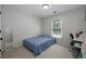 Simple bedroom with a twin bed, a study desk, and lots of natural light at 1670 Burnt Oak Way, Dacula, GA 30019