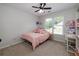 Cozy bedroom features a bed, a window, and a desk with natural light at 1670 Burnt Oak Way, Dacula, GA 30019