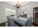 Elegant dining room with classic wainscoting, stylish chandelier, seating for eight and lots of natural light at 1670 Burnt Oak Way, Dacula, GA 30019