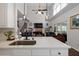 Bright kitchen with island, countertops, and seamless flow into an adjoining living space with vaulted ceilings at 1670 Burnt Oak Way, Dacula, GA 30019