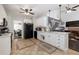 Open concept kitchen with white cabinetry, stainless steel appliances, and a seamless connection to the cozy living area at 1670 Burnt Oak Way, Dacula, GA 30019