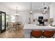 Bright, open kitchen with white cabinetry, quartz countertops, bar seating and an adjacent casual dining area at 1670 Burnt Oak Way, Dacula, GA 30019