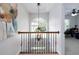 Landing featuring a chandelier, window, and decorative painting at 1670 Burnt Oak Way, Dacula, GA 30019