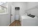 Functional laundry room with washer, dryer, and ample storage space at 1670 Burnt Oak Way, Dacula, GA 30019