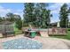 Landscaped backyard with deck, above ground pool, grilling station, patio and lush green trees at 50 Blackberry Lane, Covington, GA 30016