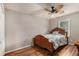 Bedroom features hardwood flooring, a ceiling fan, neutral walls, and a wooden bed at 50 Blackberry Lane, Covington, GA 30016