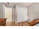 Bedroom showcases hardwood floors, neutral colored walls, a wooden bed, and double door closet at 50 Blackberry Lane, Covington, GA 30016