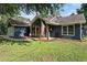 Inviting single-story home showcasing a covered front porch with American flag and a garage at 50 Blackberry Lane, Covington, GA 30016