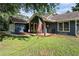 Single-story home featuring a covered front porch with American flag and a two-car garage at 50 Blackberry Lane, Covington, GA 30016