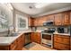 Traditional kitchen features stainless steel appliances, a window, and beautiful wood cabinetry at 50 Blackberry Lane, Covington, GA 30016