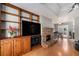 Well-lit living room featuring hardwood floors, large entertainment center, and brick fireplace at 50 Blackberry Lane, Covington, GA 30016