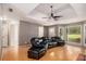 Large living room with hardwood floors, large windows, and a sectional sofa at 50 Blackberry Lane, Covington, GA 30016
