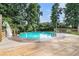 Above ground pool with deck and surrounding trees, with a clear and inviting atmosphere at 50 Blackberry Lane, Covington, GA 30016