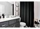 Well-lit bathroom with dark vanity, framed artwork and modern fixtures at 510 Oak Dr, Hapeville, GA 30354