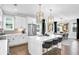 Modern kitchen featuring stainless steel appliances, white cabinets, pendant lights, and an island with bar stools at 510 Oak Dr, Hapeville, GA 30354