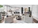 Open-concept living area with kitchen, bar seating, and dining, all with hardwood floors and stylish decor at 510 Oak Dr, Hapeville, GA 30354