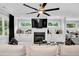 Bright living room features a ceiling fan, fireplace, built-in cabinets, and a wall-mounted TV at 510 Oak Dr, Hapeville, GA 30354
